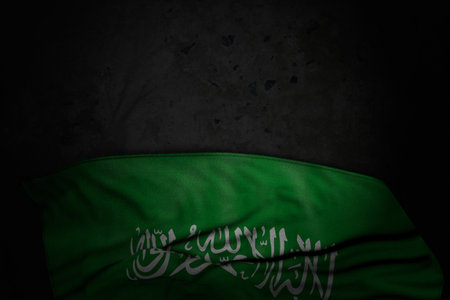 pretty dark picture of Saudi Arabia flag with big folds on black stone with free space for your text - any celebration flag 3d illustrationの写真素材