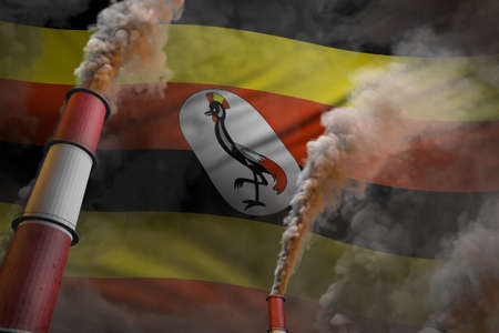 Uganda pollution fight concept - two huge industry pipes with heavy smoke on flag background, industrial 3D illustrationの写真素材