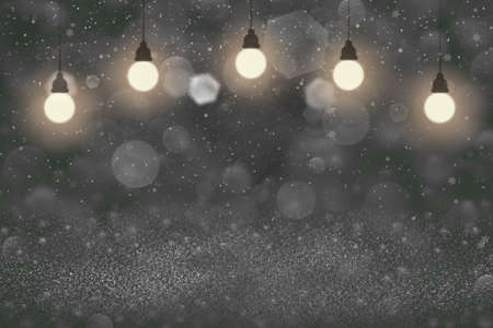 green nice brilliant abstract background glitter lights with light bulbs and falling snow flakes fly...