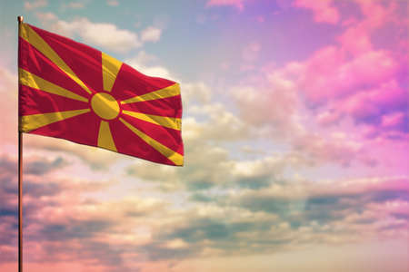 Fluttering Macedonia flag mockup with the place for your text on colorful cloudy sky background.の写真素材