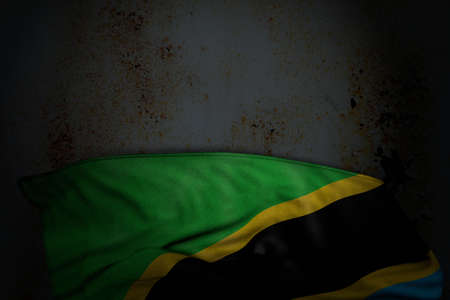 cute anthem day flag 3d illustration - dark image of Tanzania flag with large folds on rusty metal with empty place for textの写真素材