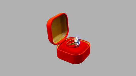 Red - goldish opened bijouterie present with diamond wedding ring on grey, isolated, fictive -...
