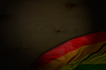 cute dark image of Gay Pride flag with big folds on dark wood with free place for content - any feast flag 3d illustrationの写真素材