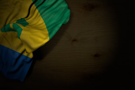 pretty dark picture of Saint Vincent and the Grenadines flag with large folds on dark wood with free space for your content - any occasion flag 3d illustrationの写真素材