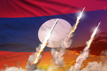 Lao People Democratic Republic supersonic missile launch - modern strategic nuclear rocket weapons concept on sunset background, military industrial 3D illustration with flagの写真素材