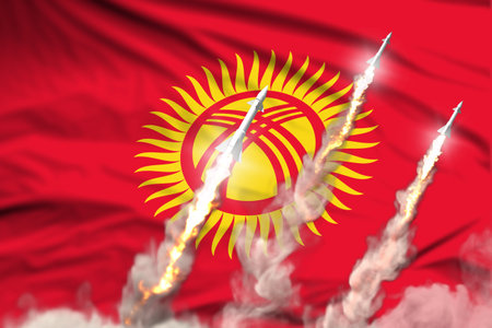 Kyrgyzstan supersonic missile launch - modern strategic nuclear rocket weapons concept on flag fabric background, military industrial 3D illustration with flagの写真素材