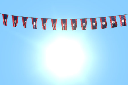 pretty many Lao People Democratic Republic flags or banners hangs on rope on blue sky background - any celebration flag 3d illustrationの写真素材
