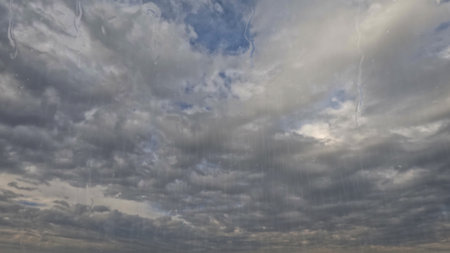 rainfall on sky with clouds - pretty weather bg - photo of natureの写真素材