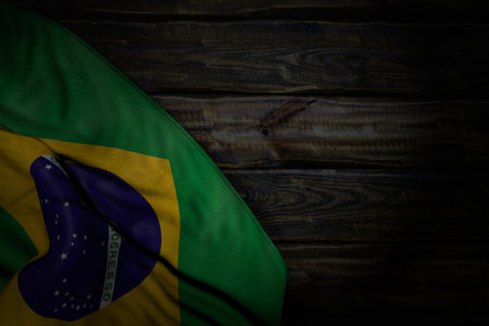 pretty labor day flag 3d illustration - dark picture of Brazil flag with large folds on old wood with free place for contentの写真素材