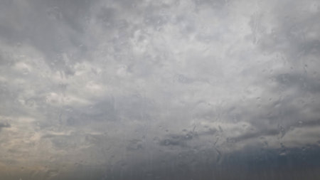 falling rain on sky with clouds - pretty weather background - photo of natureの写真素材