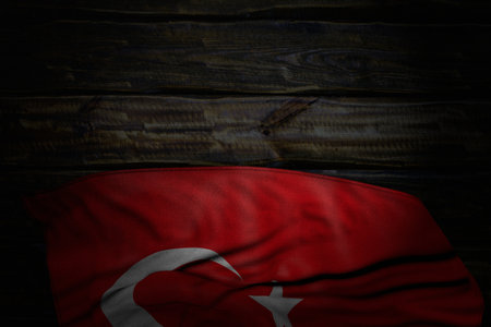 wonderful dark picture of Turkey flag with large folds on old wood with free space for your text - any feast flag 3d illustrationの写真素材