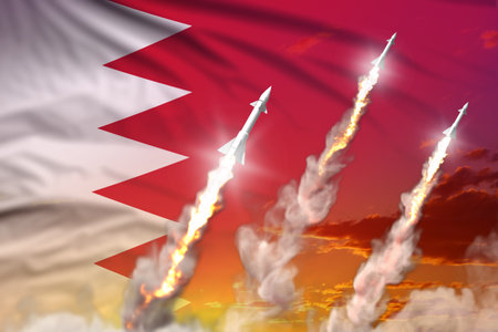 Modern strategic rocket forces concept on sunset background, Bahrain supersonic warhead attack - military industrial 3D illustration, nuke with flagの写真素材
