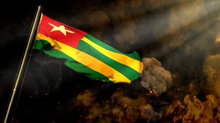 defocused Togo flag on smoke with sun rays bg - problems concept - abstract 3D illustrationの写真素材