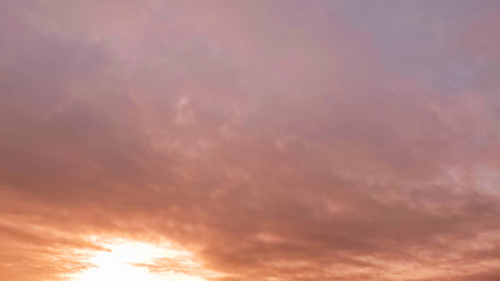 pretty sundown goldish clouds on the sky backdrop - photo of natureの写真素材