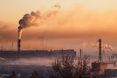 smoke from pipes in front of sunrise
