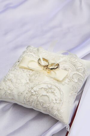Wedding rings on the pillowの写真素材