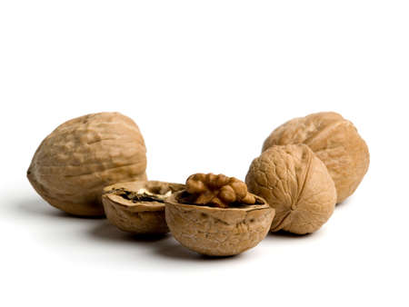 Open and closed walnuts on white background