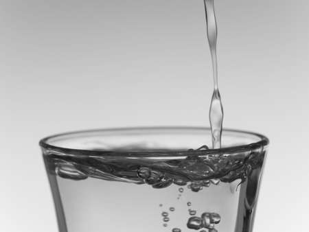 Pouring a shot of vodka.の写真素材