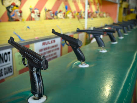 Aiming attraction with several wold war II styled toy guns.の写真素材
