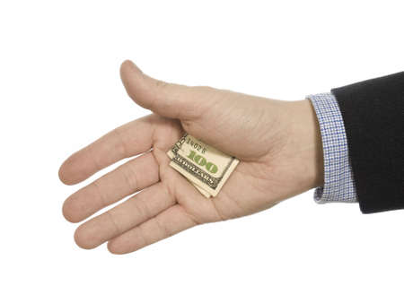 A man's hand hiding a hundred dollars tip.