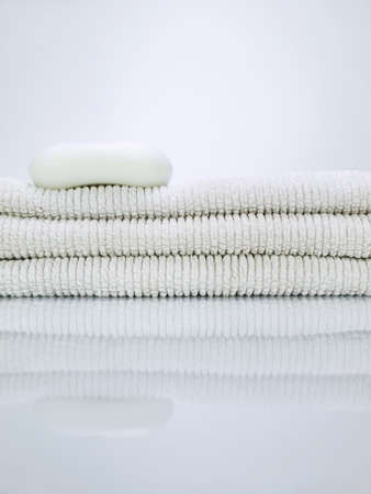 A soap over a pile of towels.の写真素材