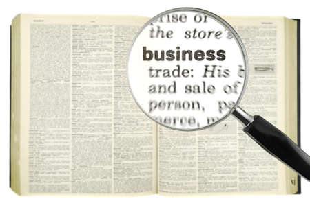A magnifying glass on the word BUSINESS on a dictionary.の写真素材