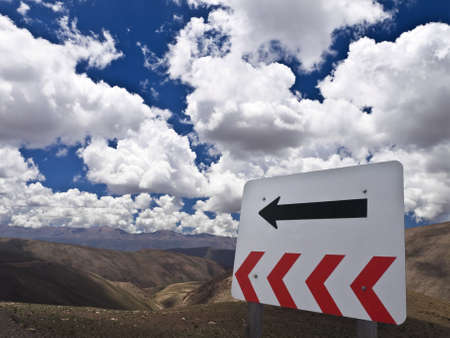 A TURN sign over the hill. Flip it to go right.