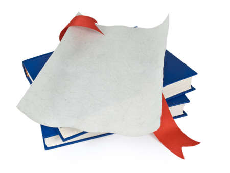 An open diploma with red ribbon over blue books. Isolated on white.の写真素材