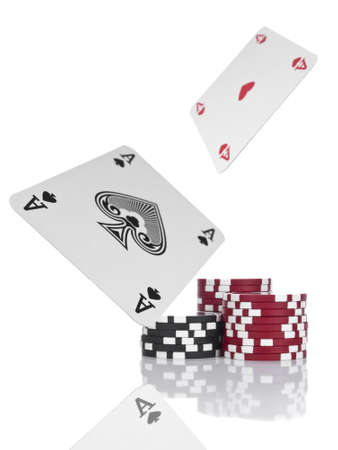 Two aces flying over piles of gambling chips. Isolated on white.のeditorial素材