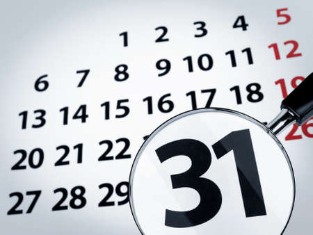 A magnifying glass on the 31st day of a calendar page.の写真素材