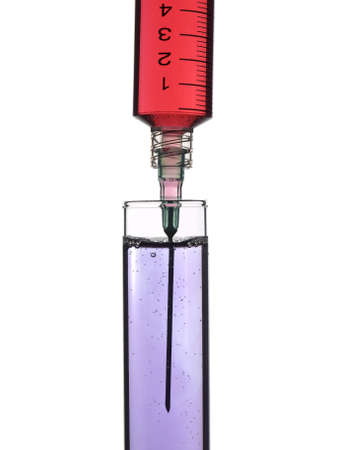 Syringe drooping sample on a test tube. Isolated on white.の写真素材