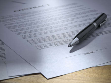 Close up of a pen over a contract to be signed.