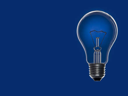 Turned off light bulb over a blue background. Copy space.の写真素材