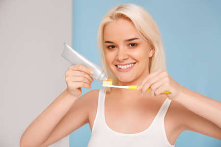 Woman with beautiful smile, healthy white teeth with toothbrush. High resolution image