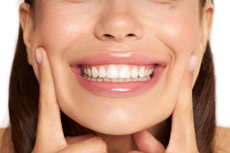 Closeup of a beautiful smile with white teeth. Woman mouth smiling. High resolution image