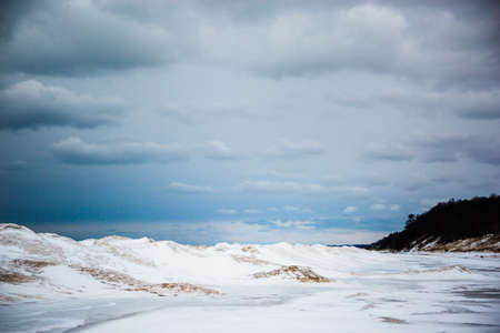 Sand dunes and frozen waves on cloudy day