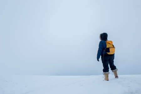 Woman alone in snowstormの写真素材