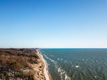 Aerial view of a chilly coastline on a sunny day in springの写真素材