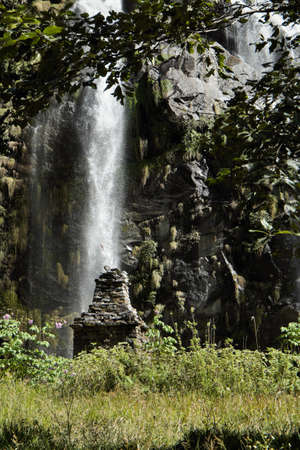 Waterfall in the mountains in Nepal among green plantsの写真素材