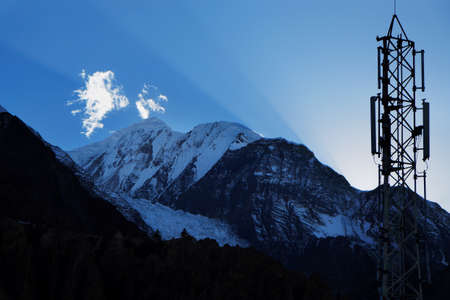 Sun rays and cellular transmitter in the sky over the Himalayasの写真素材