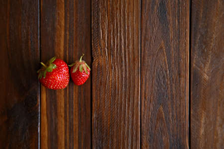 juicy strawberries on wooden backgroundの写真素材