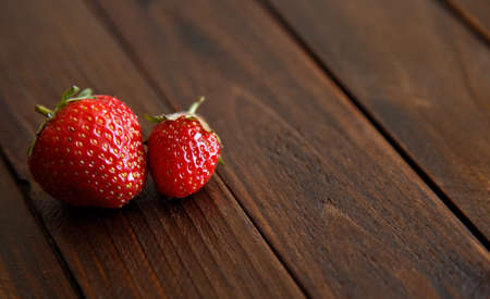juicy strawberries on wooden backgroundの写真素材