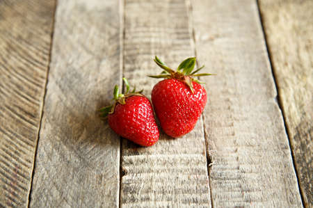 juicy strawberries on wooden backgroundの写真素材