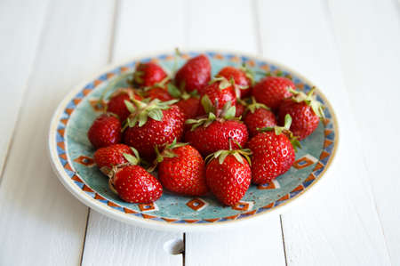 juicy strawberries on wooden backgroundの写真素材