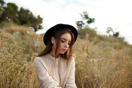 beautiful cute girl in a dress in natureの写真素材