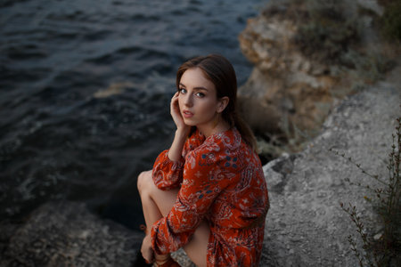 beautiful cute girl in a dress in natureの写真素材