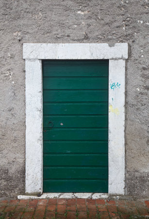 Green door in an old building with graffiti on the wall, Spainの写真素材
