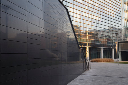 Exterior of modern office building with glass wall and concrete floor.の写真素材