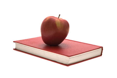 A red apple on an old red book.の写真素材