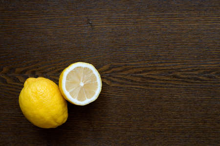 Lemons on a wooden table in the lest lower corner.の写真素材